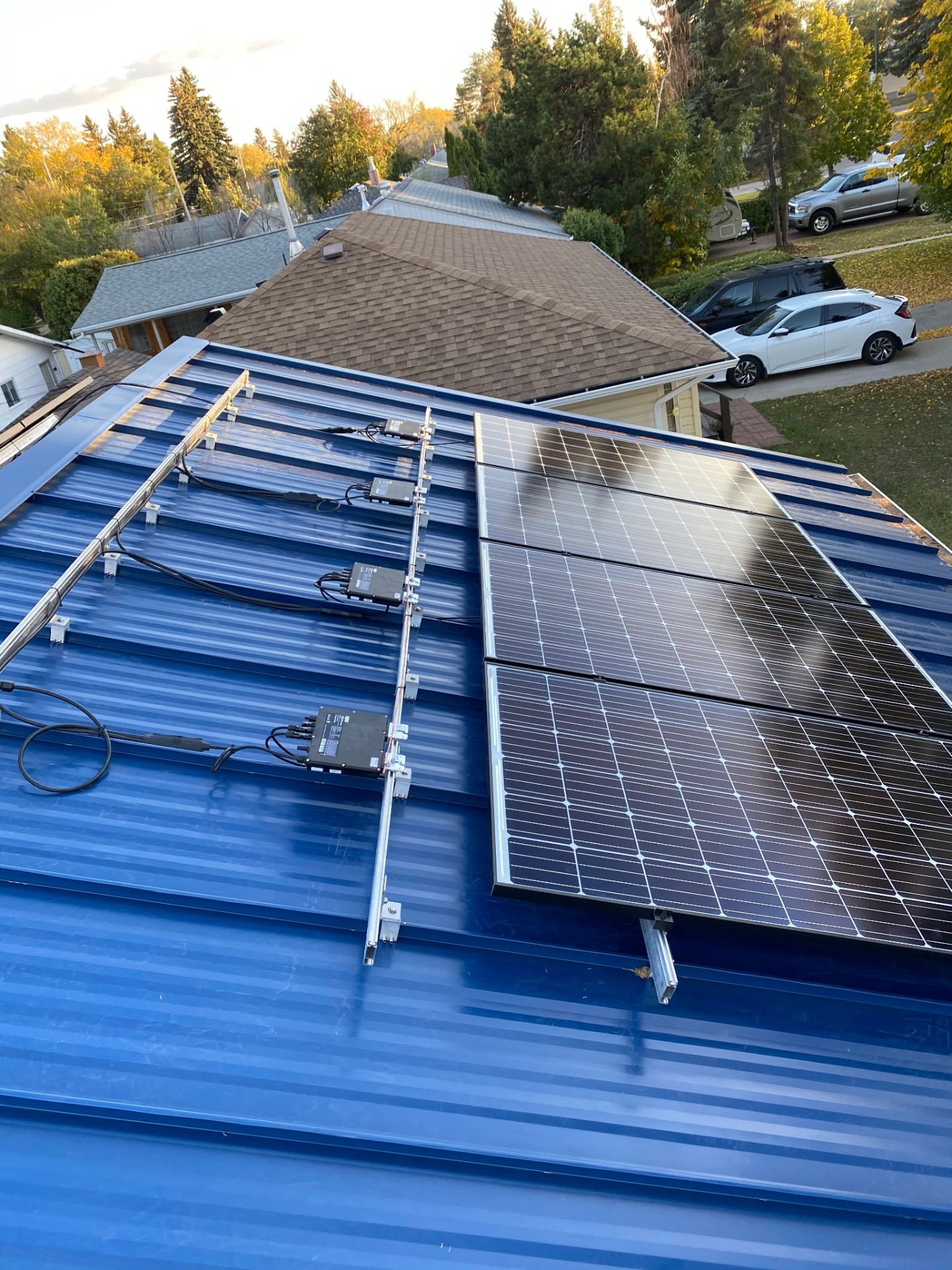 Non-penetrating seam clamps holding solar racking on a standing seam metal roof