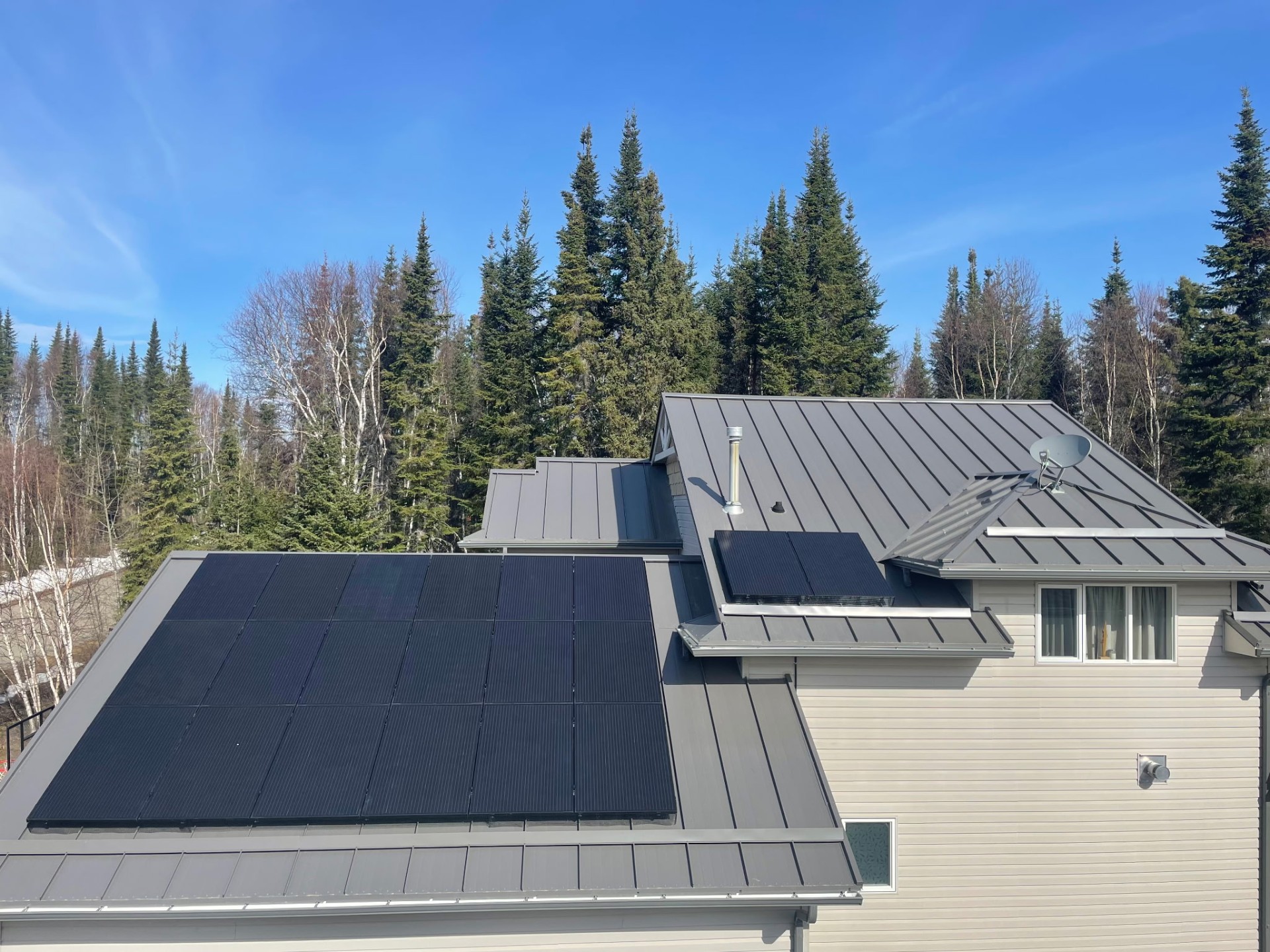 Completed solar array on a charcoal standing seam metal roof at a Saskatchewan home