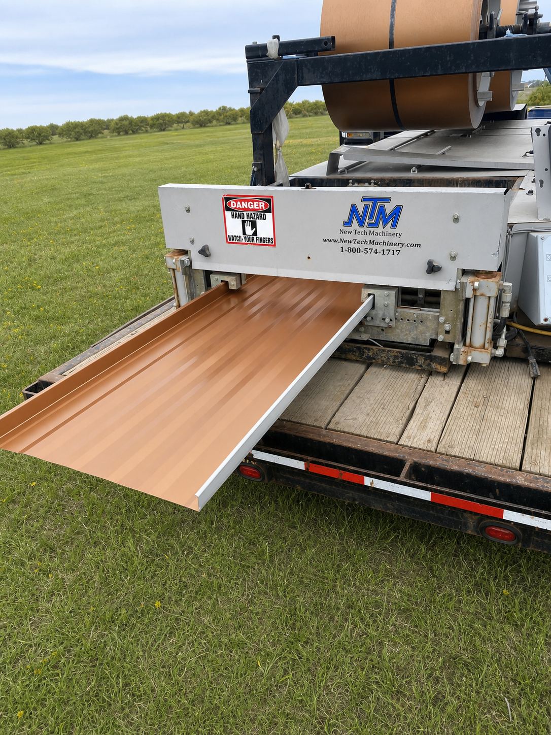 Mobile roll-forming trailer producing seamless metal panels on-site